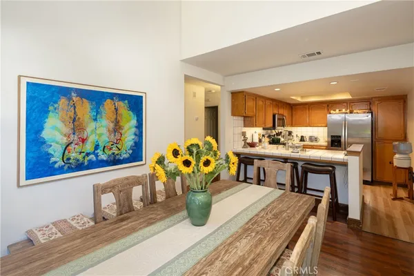 a living room with kitchen island furniture and a potted plant