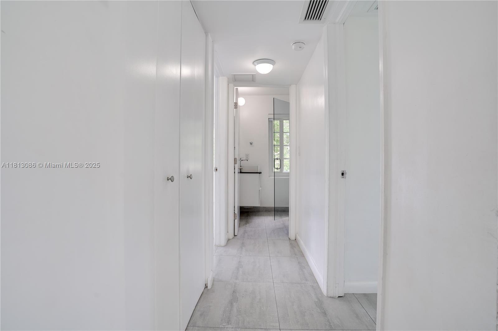 1201 South Biscayne Point Road Miami Beach, FL 33141 - Photo 14 of 35 a view of a hallway with wooden floor