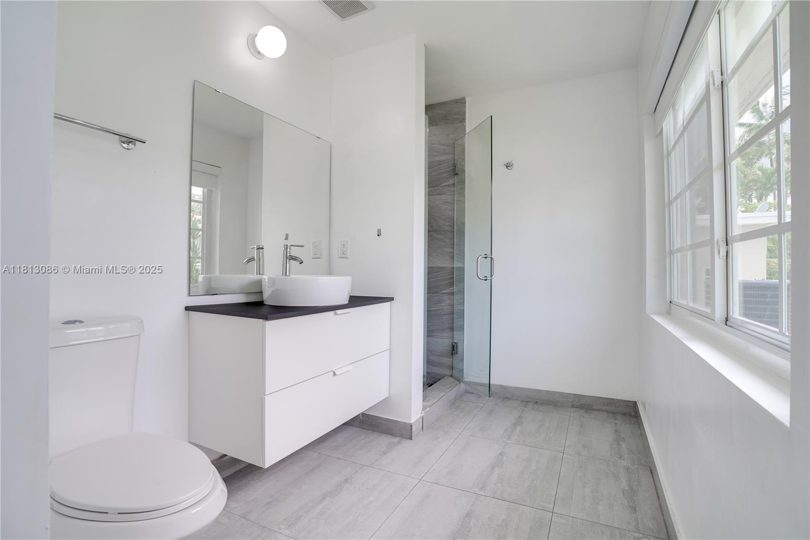 1201 South Biscayne Point Road Miami Beach, FL 33141 - Photo 21 of 35 a bathroom with a sink a toilet and shower