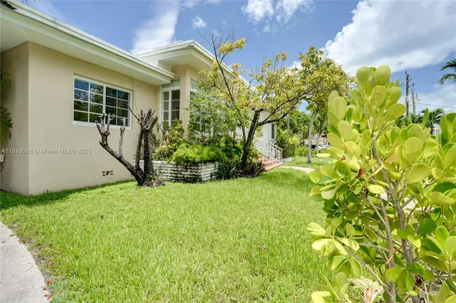 a front view of house with yard and green space