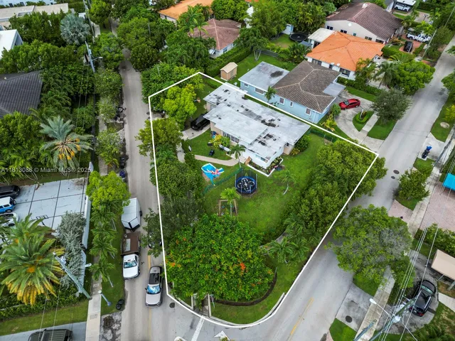 an aerial view of a house with a yard