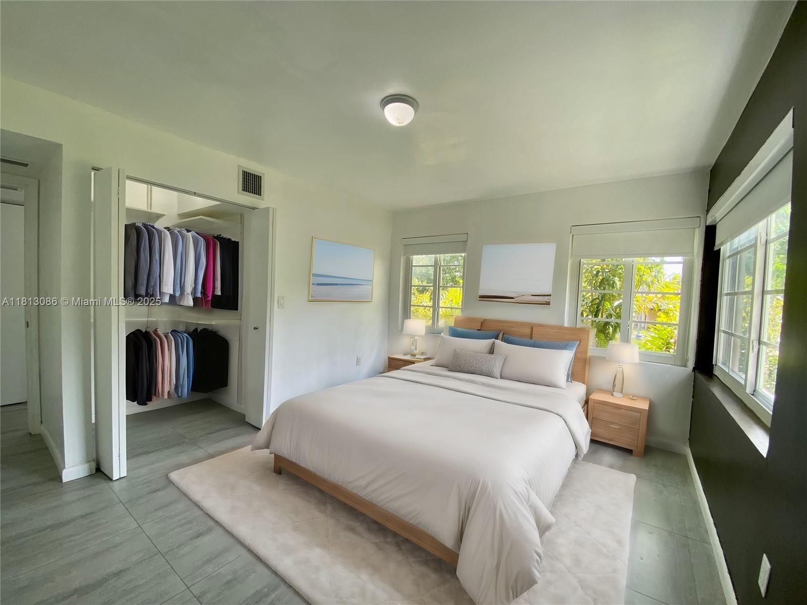 1201 South Biscayne Point Road Miami Beach, FL 33141 - Photo 6 of 35 a bedroom with a large bed and a large window