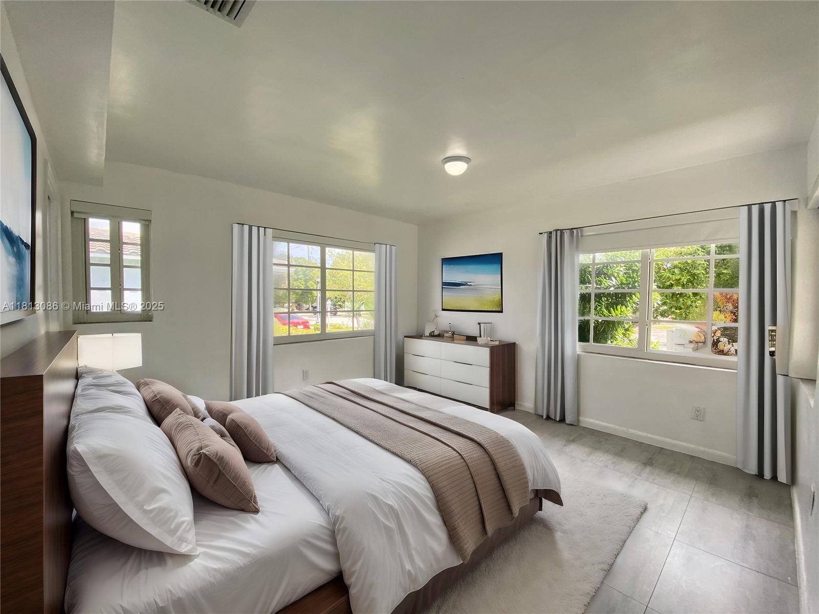 1201 South Biscayne Point Road Miami Beach, FL 33141 - Photo 7 of 35 a bedroom with a large bed and a window