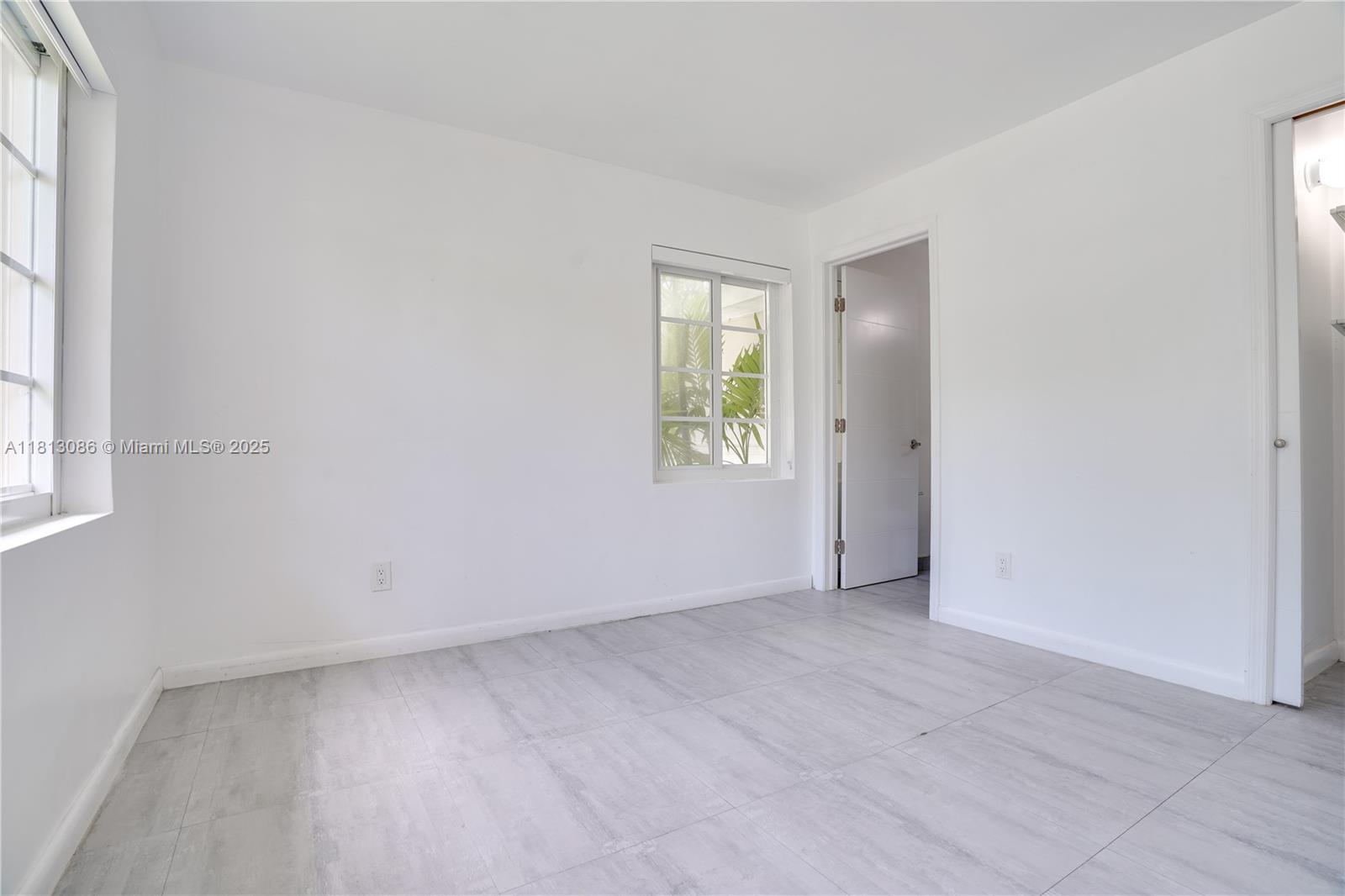 1201 South Biscayne Point Road Miami Beach, FL 33141 - Photo 10 of 35 an empty room with windows