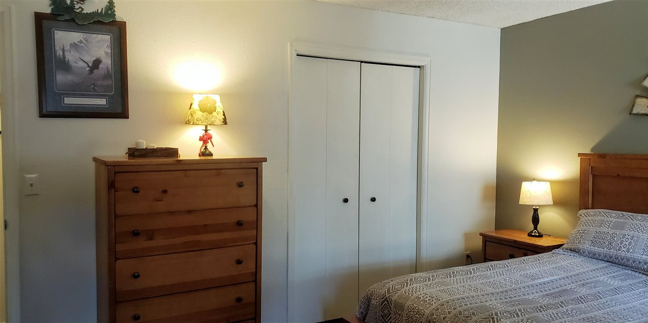 406 Ridges Boulevard, Unit 18 Grand Junction, CO 81507 - Photo 18 of 25 a bedroom with a bed and a dresser