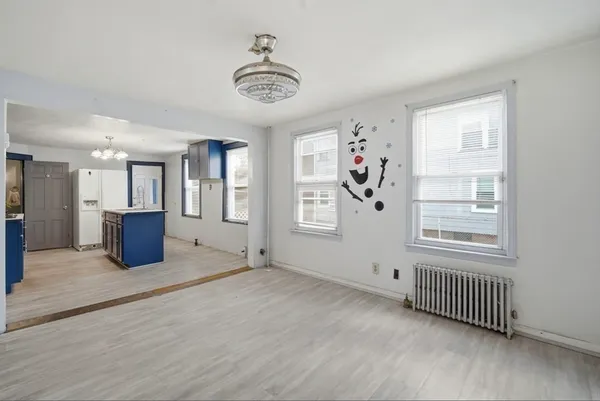 a view of a big room with windows and cabinet