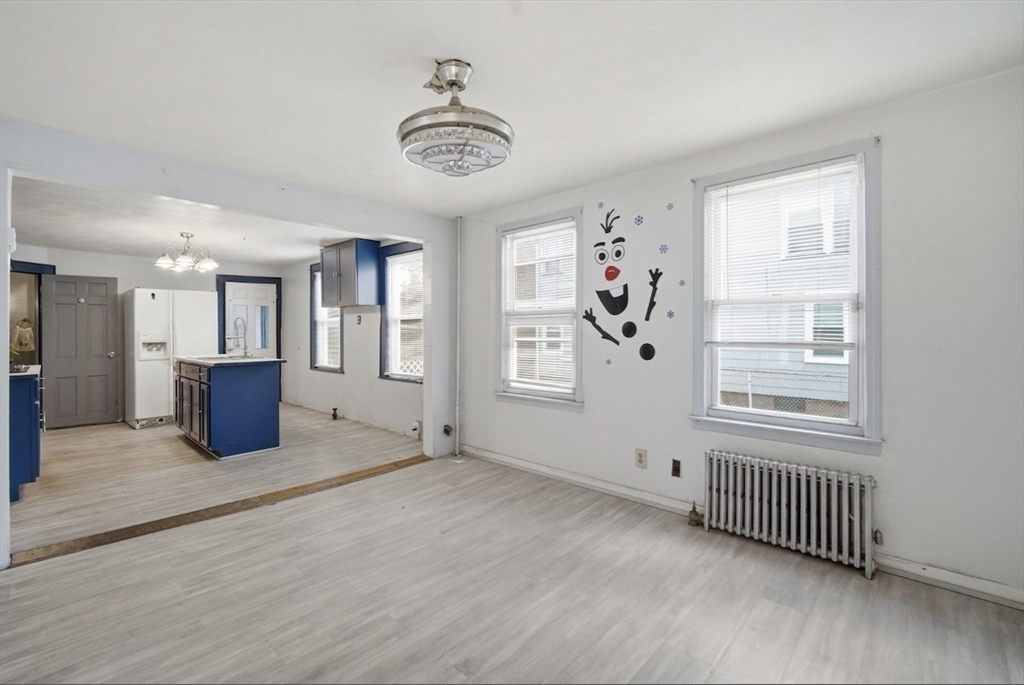 53 Fremont Street, Unit 1 Springfield, MA 01105 - Photo 3 of 9 a view of a big room with windows and cabinet