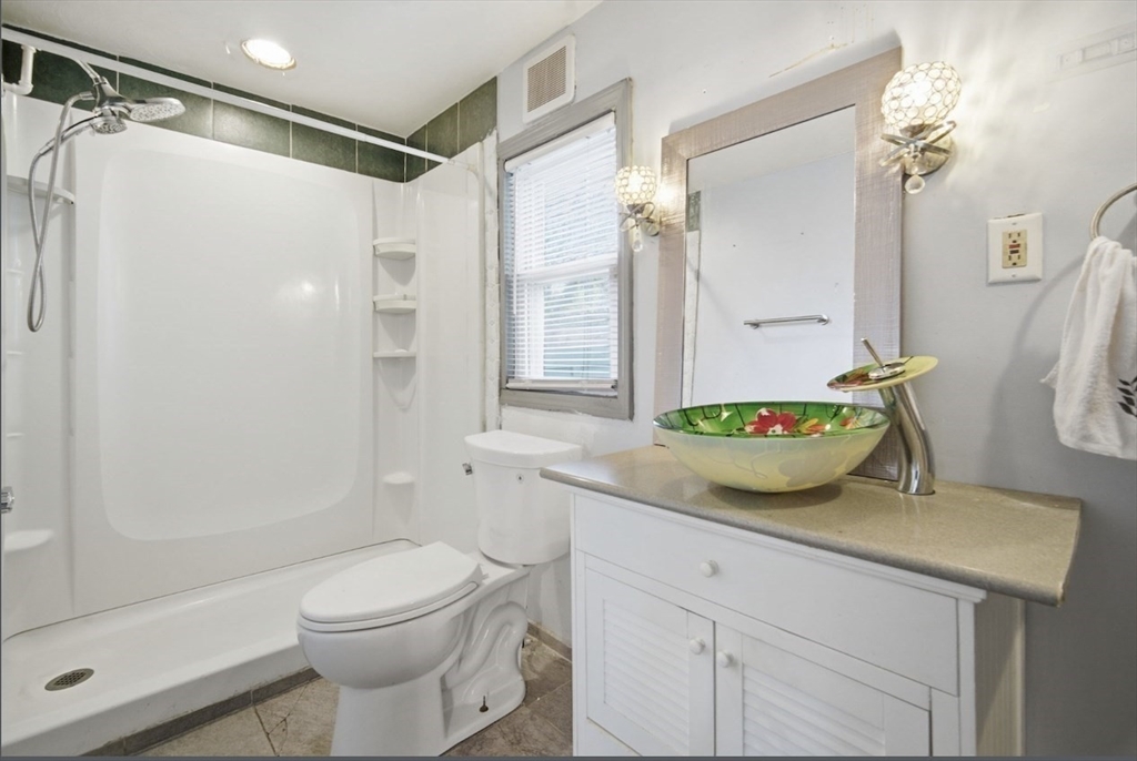 53 Fremont Street, Unit 1 Springfield, MA 01105 - Photo 8 of 9 a bathroom with a granite countertop sink toilet and shower