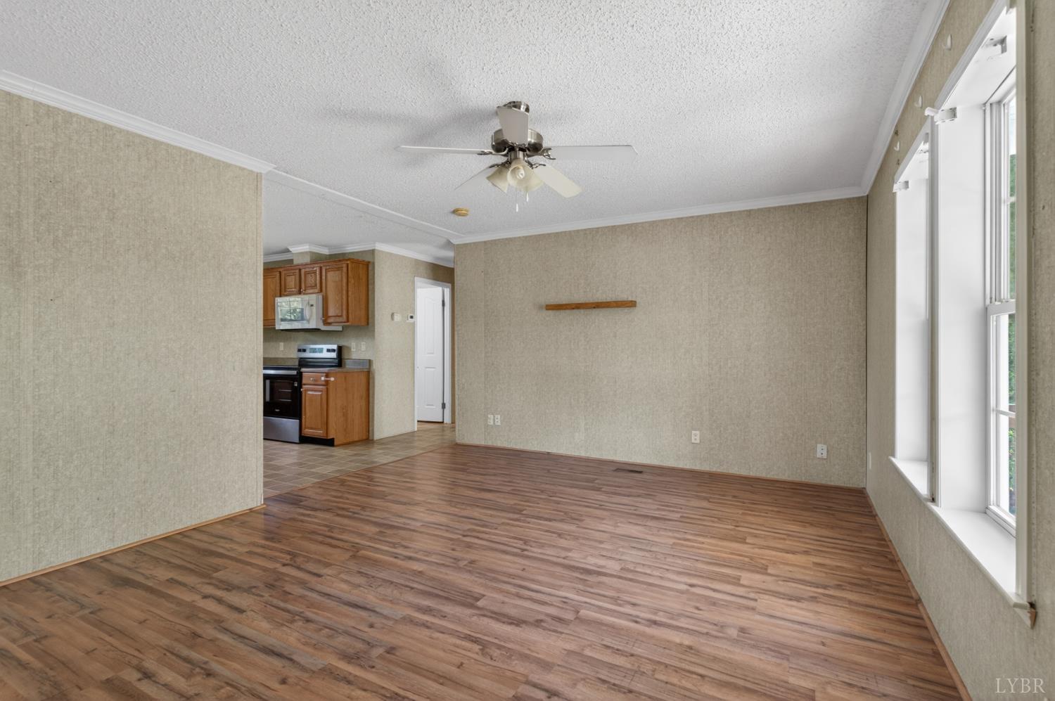 1811 Mohawk Road Gladys, VA 24554 - Photo 6 of 51 wooden floor in an empty room with a kitchen