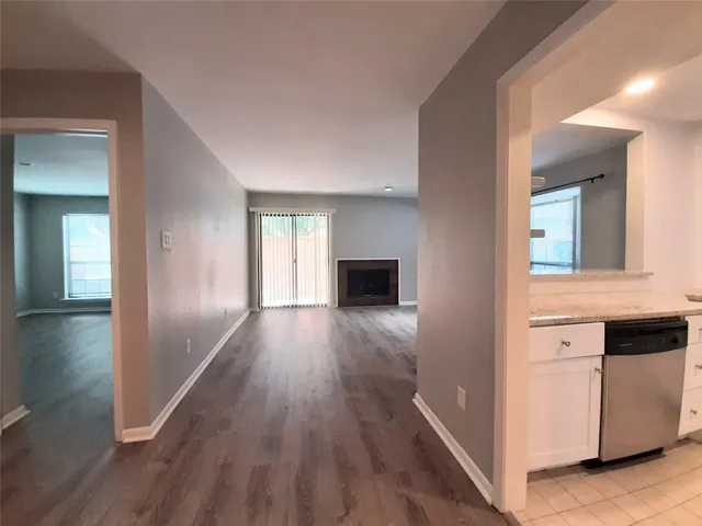 a view of hallway with wooden floor