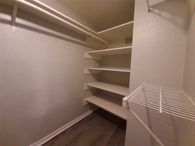 a view of room with wooden floor