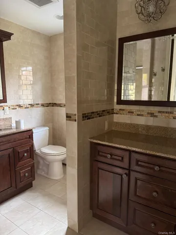 a bathroom with a sink a toilet and mirror