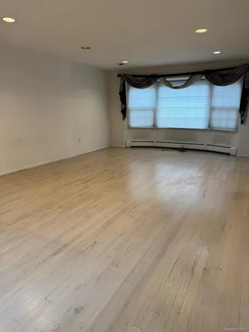 a view of room with wooden floor