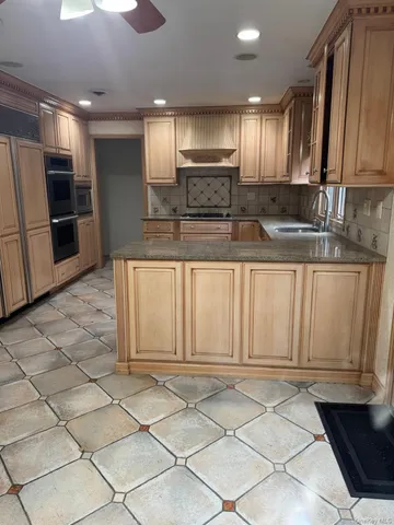 a view of kitchen with refrigerator cabinets and barbecue grill