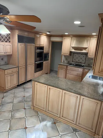 a kitchen with stainless steel appliances granite countertop a sink and a stove