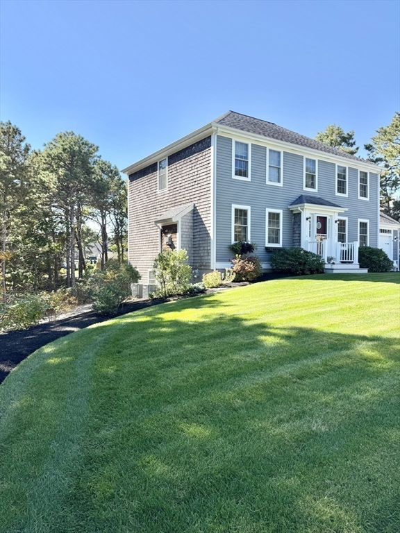 12 Wintergreen Road Mashpee, MA 02649 - Photo 1 of 40 a front view of house with yard and trees in the background
