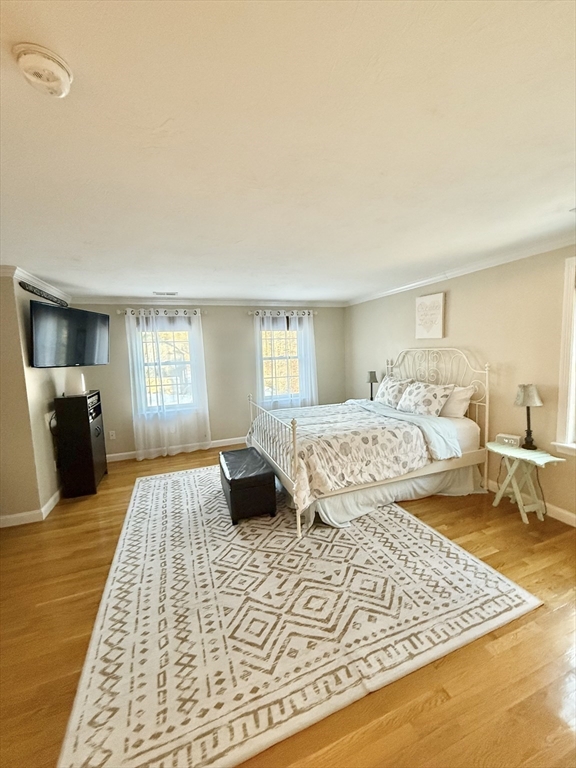 12 Wintergreen Road Mashpee, MA 02649 - Photo 23 of 40 a bedroom with a large bed and wooden floor