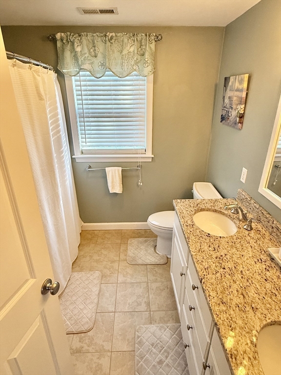 12 Wintergreen Road Mashpee, MA 02649 - Photo 25 of 40 a bathroom with a granite countertop sink a toilet and shower