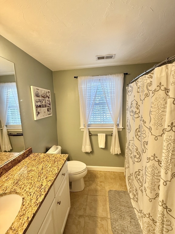 12 Wintergreen Road Mashpee, MA 02649 - Photo 28 of 40 a bathroom with a granite countertop sink and a mirror