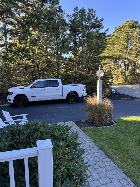 12 Wintergreen Road Mashpee, MA 02649 - Photo 4 of 40 a view of a yard with cars parked