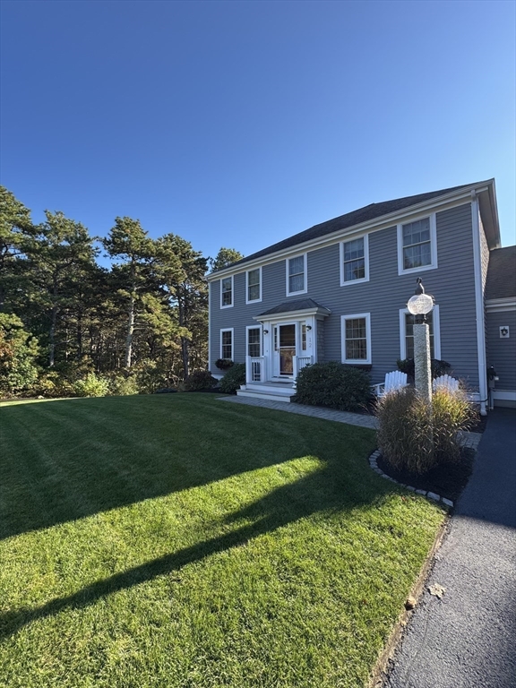 12 Wintergreen Road Mashpee, MA 02649 - Photo 5 of 40 a front view of a house with a garden