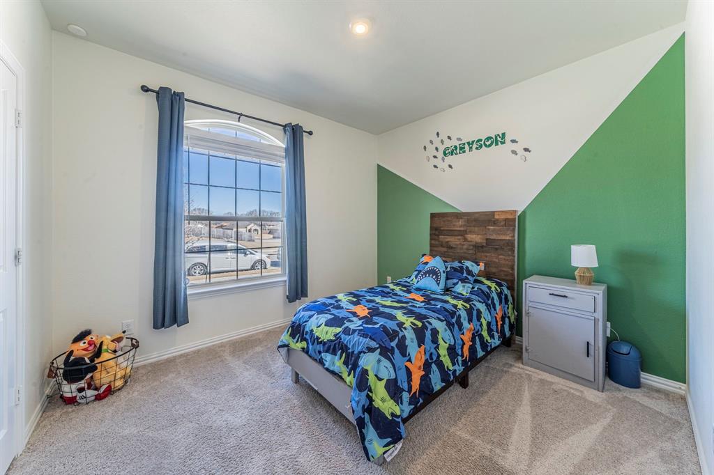 1240 Almond Road Azle, TX 76020 - Photo 14 of 26 a bedroom with a bed and a window