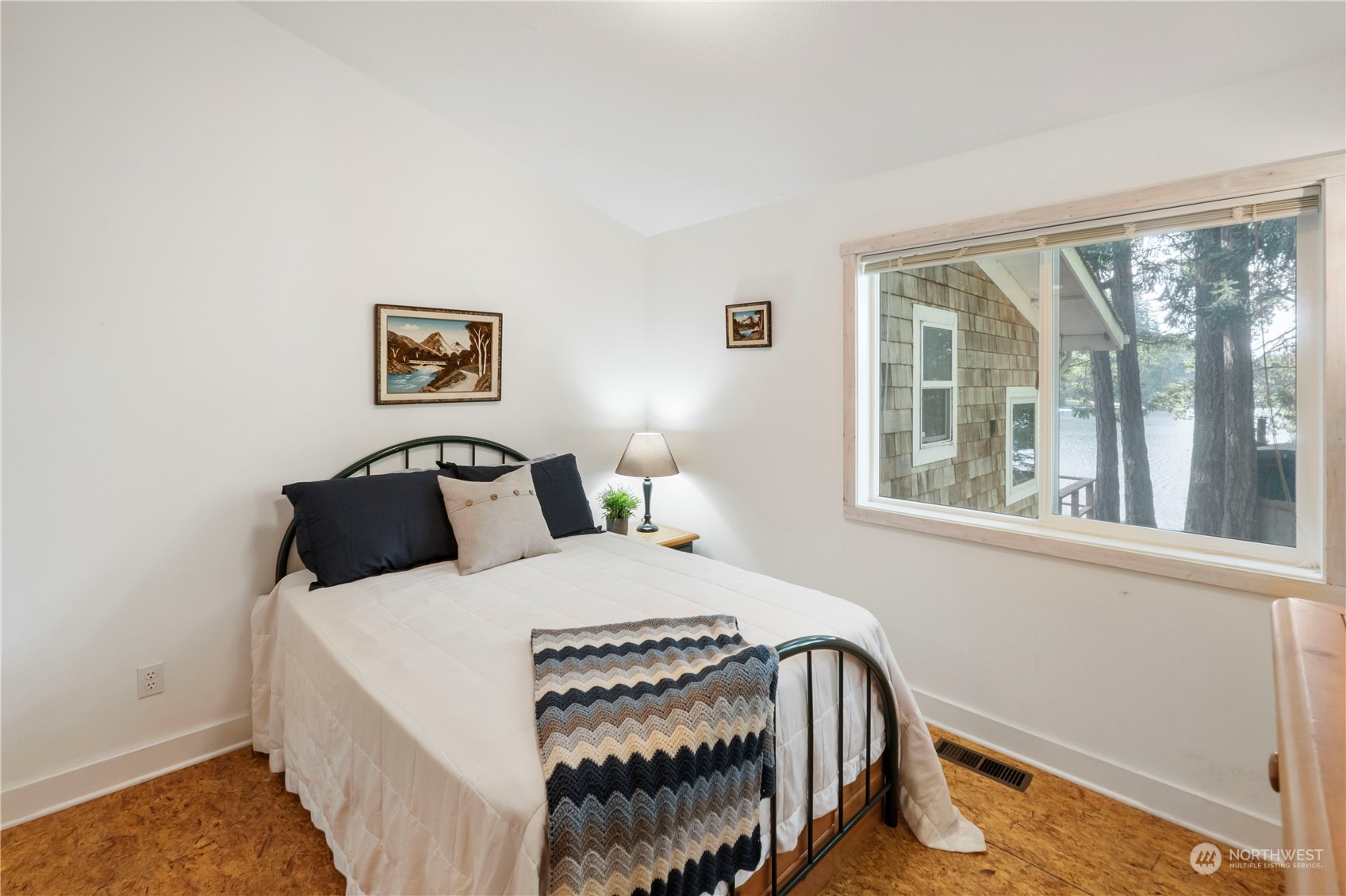720 East Phillips Lake Loop Road Shelton, WA 98584 - Photo 19 of 31 a bedroom with a bed a painting on the wall and a window