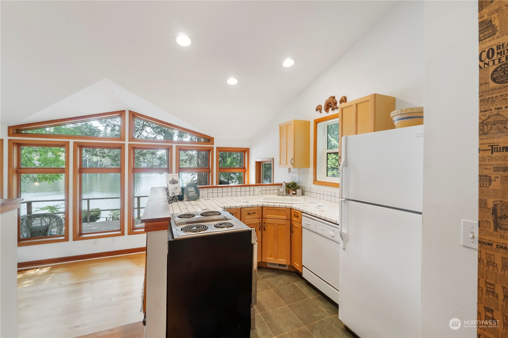720 East Phillips Lake Loop Road Shelton, WA 98584 - Photo 8 of 31 a kitchen with a refrigerator a stove and a large window