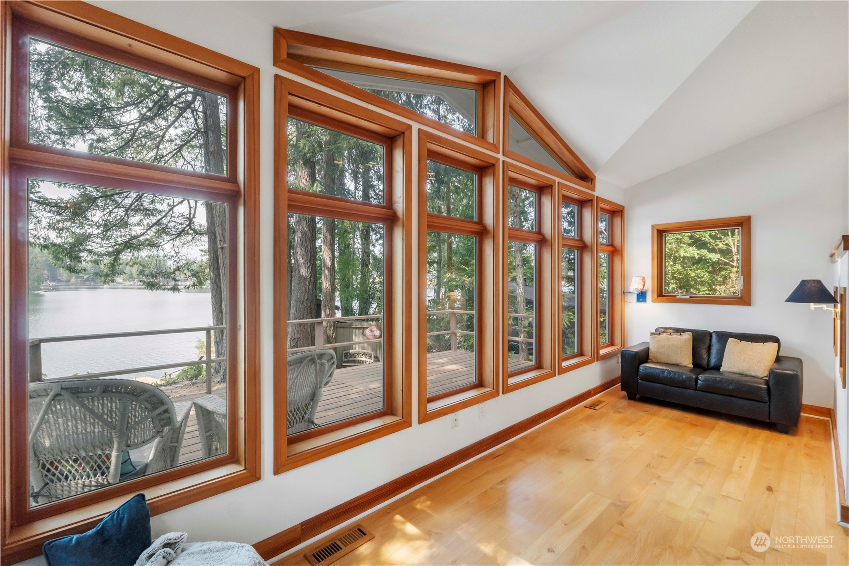 720 East Phillips Lake Loop Road Shelton, WA 98584 - Photo 10 of 31 a living room filled with furniture and a floor to ceiling window