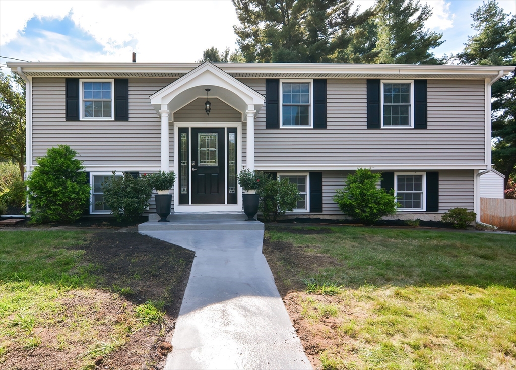 7 Northgate Road Franklin, MA 02038 - Photo 2 of 42 a front view of a house with garden