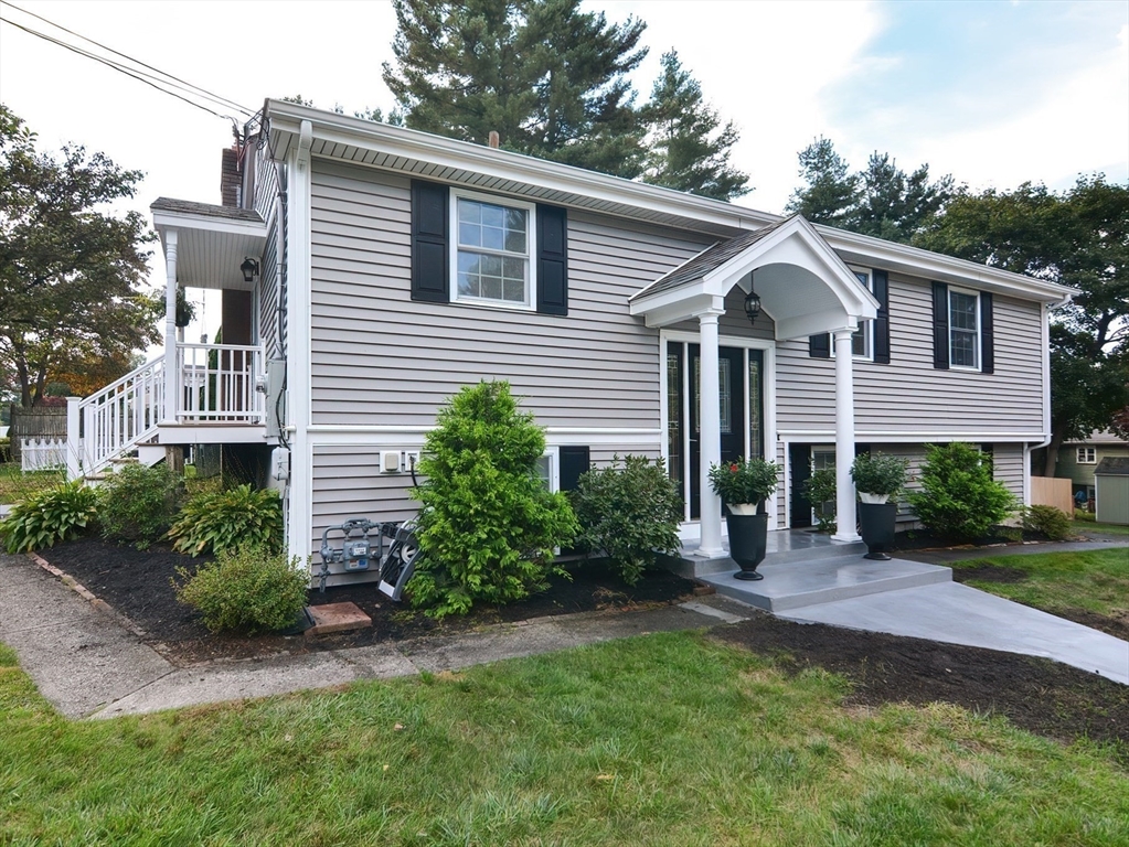 7 Northgate Road Franklin, MA 02038 - Photo 3 of 42 a front view of a house with a garden