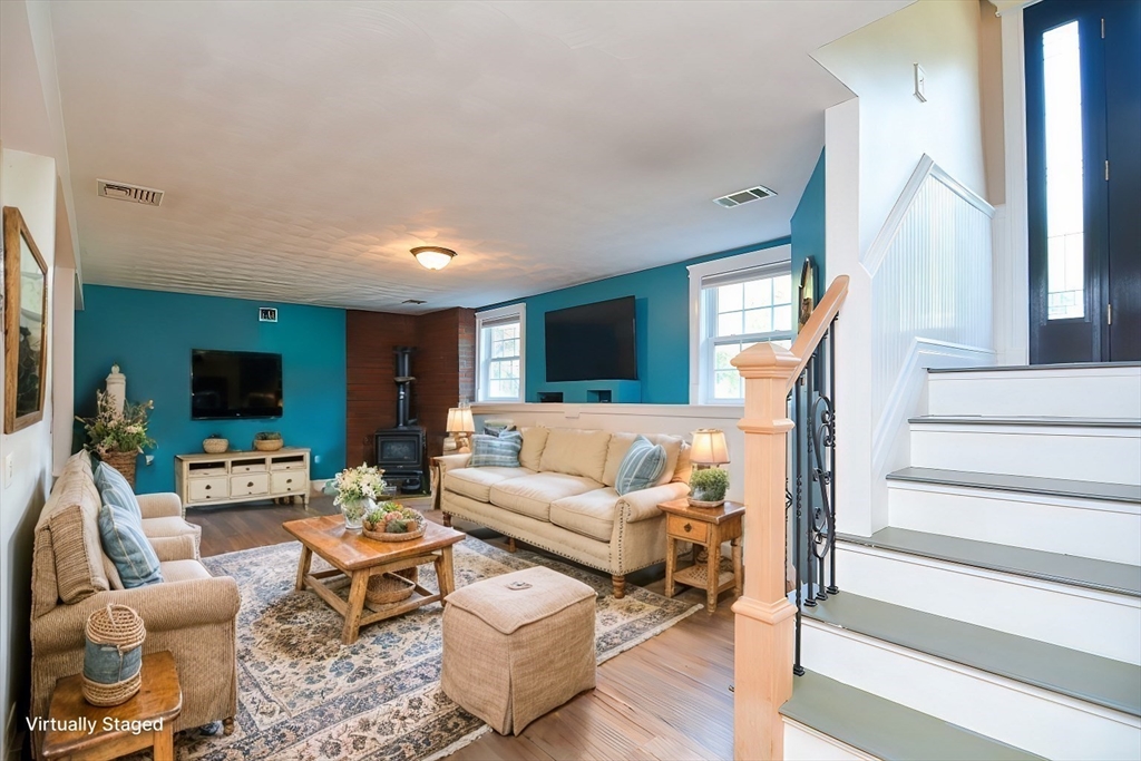 7 Northgate Road Franklin, MA 02038 - Photo 32 of 42 a living room with furniture flat screen tv and a fireplace