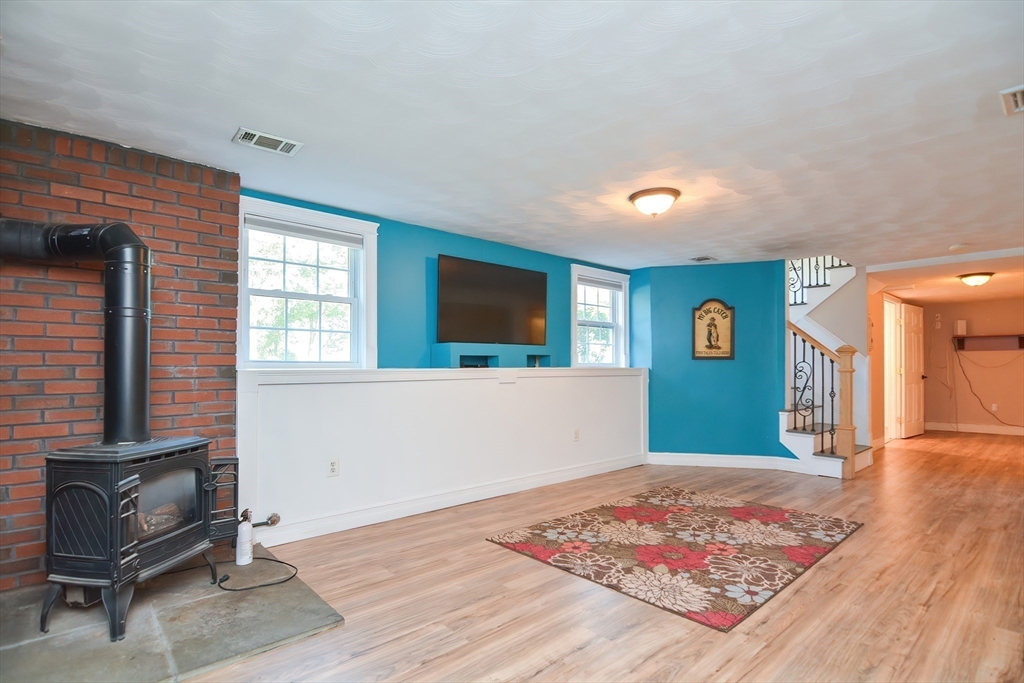 7 Northgate Road Franklin, MA 02038 - Photo 33 of 42 a living room with a couch and a flat screen tv