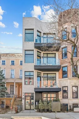a front view of a residential apartment building with a yard