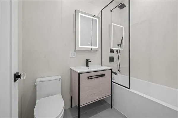 a bathroom with a toilet sink and mirror