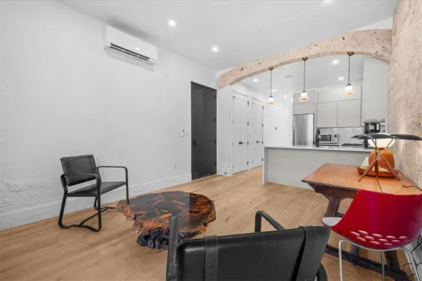 a living room with furniture and a wooden floor