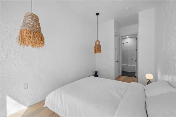 a bedroom with a bed and a chandelier