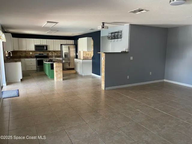 a open kitchen with cabinets and stainless steel appliances