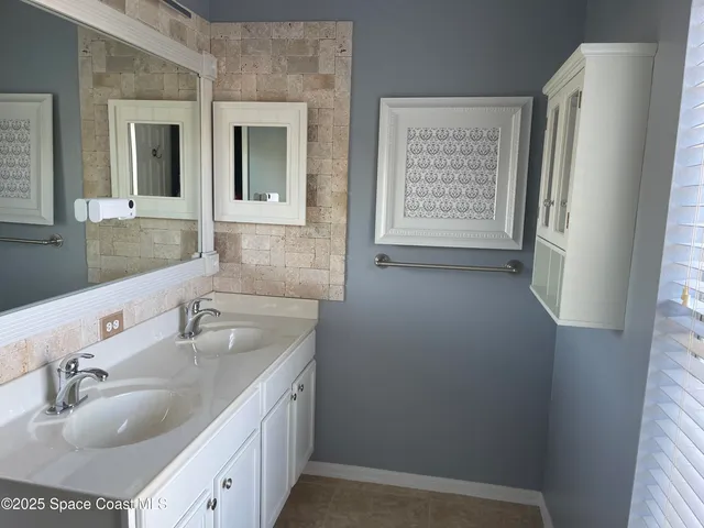 a bathroom with a double vanity sink and a mirror