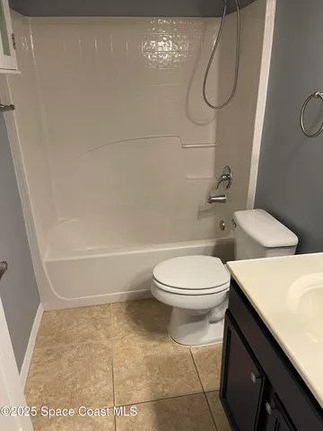 a bathroom with a toilet and shower