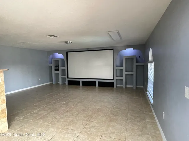 a view of room with a flat screen tv