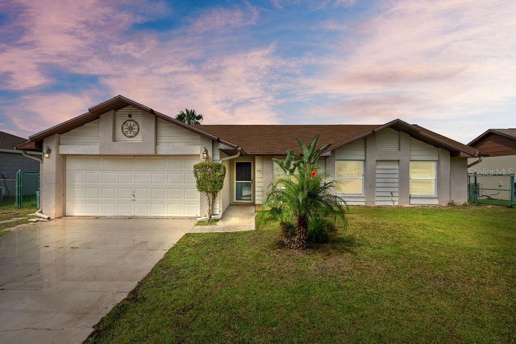 a front view of a house with a garden and yard