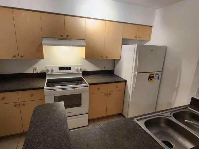 a kitchen with a stove and a refrigerator