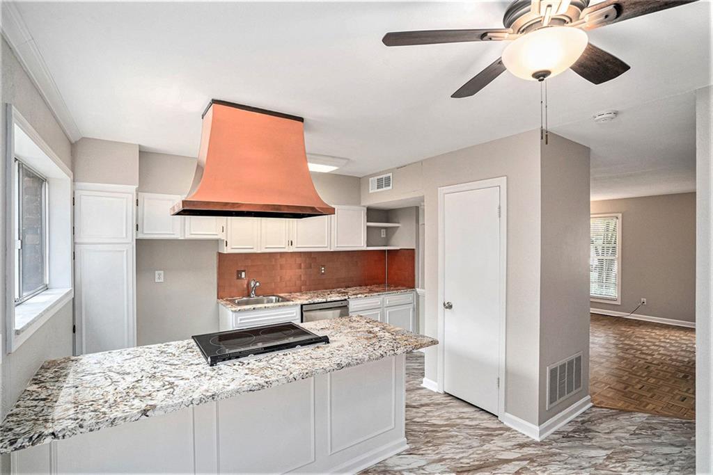 a kitchen with stainless steel appliances granite countertop a sink and a refrigerator