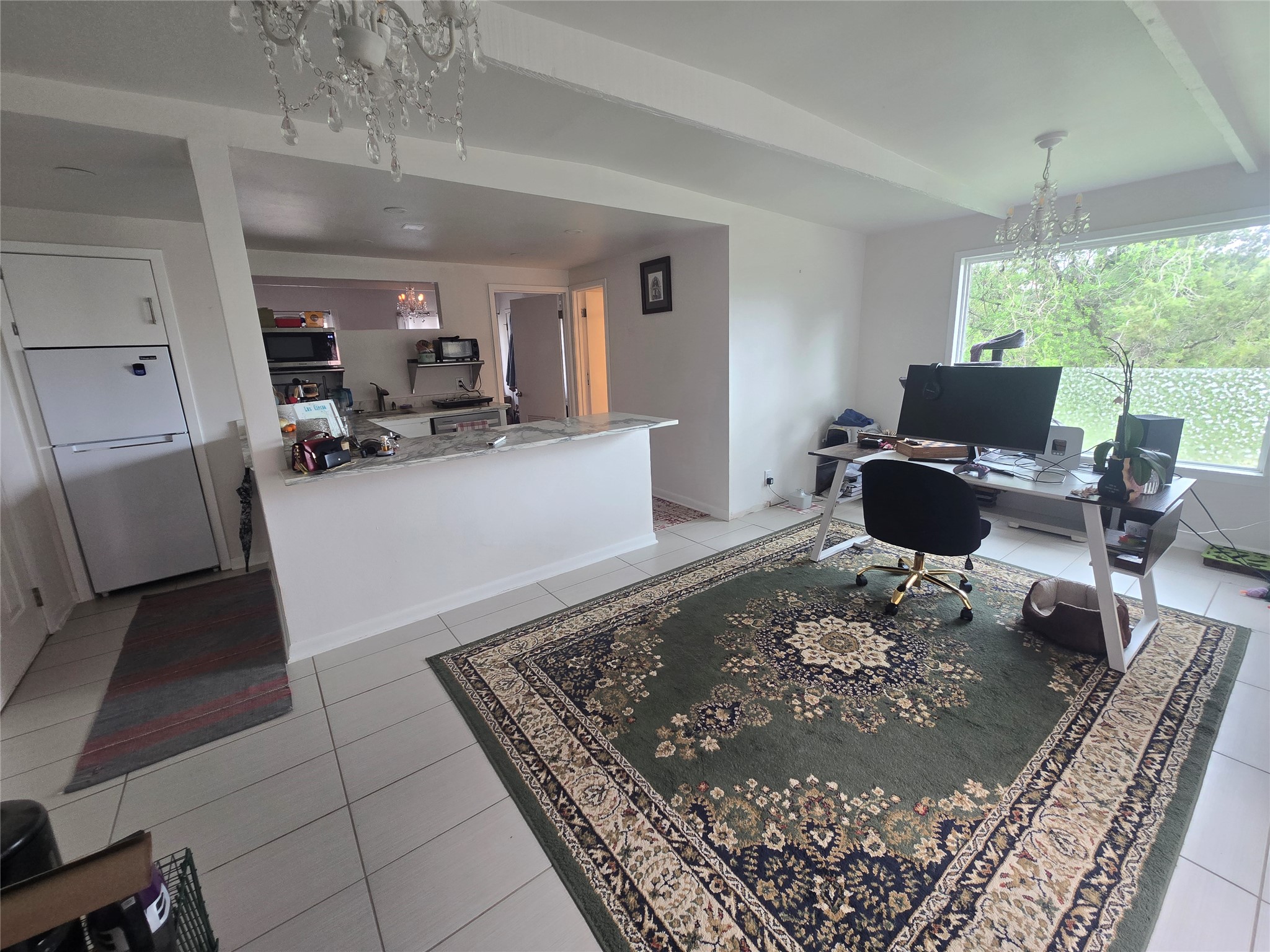 1106 The High Road, Unit A Austin, TX 78746 - Photo 3 of 12 Office area with hanging lights and light tile patterned floors