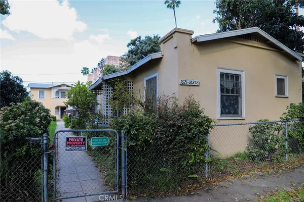 a front view of a house with plants