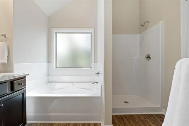 a bathroom with a bathtub and a shower