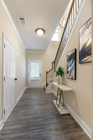 a view of an entryway and wooden floor