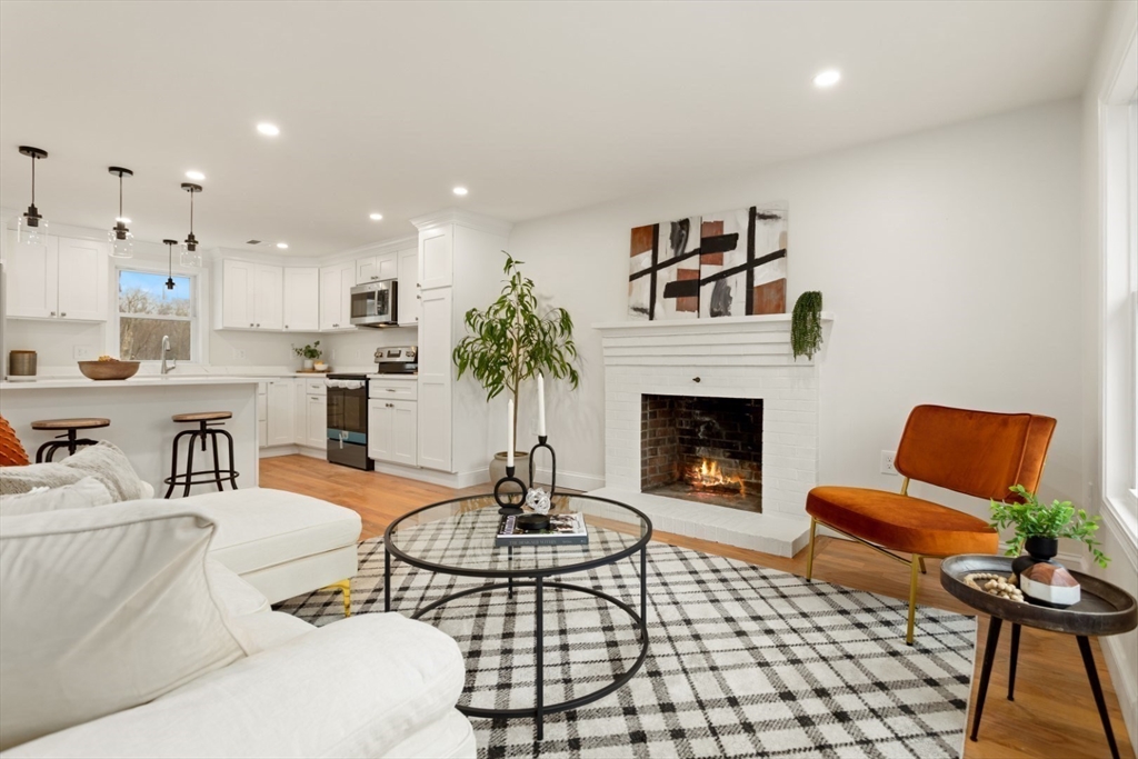 83 Riverbank Road Saugus, MA 01906 - Photo 12 of 36 a living room with furniture and a fireplace