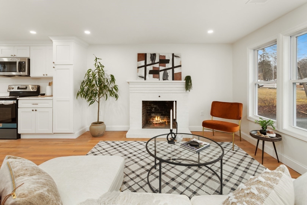 83 Riverbank Road Saugus, MA 01906 - Photo 13 of 36 a living room with furniture and a fireplace